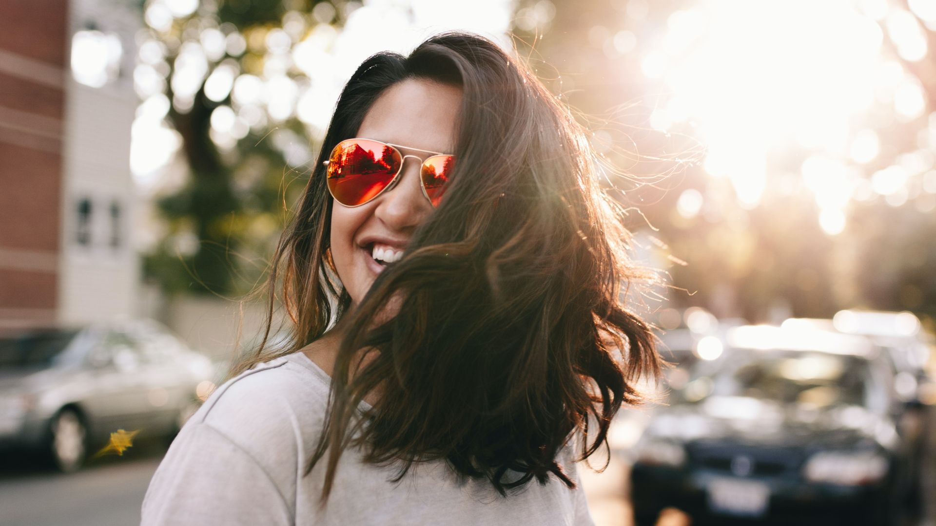 Happy woman, sun beam behind her